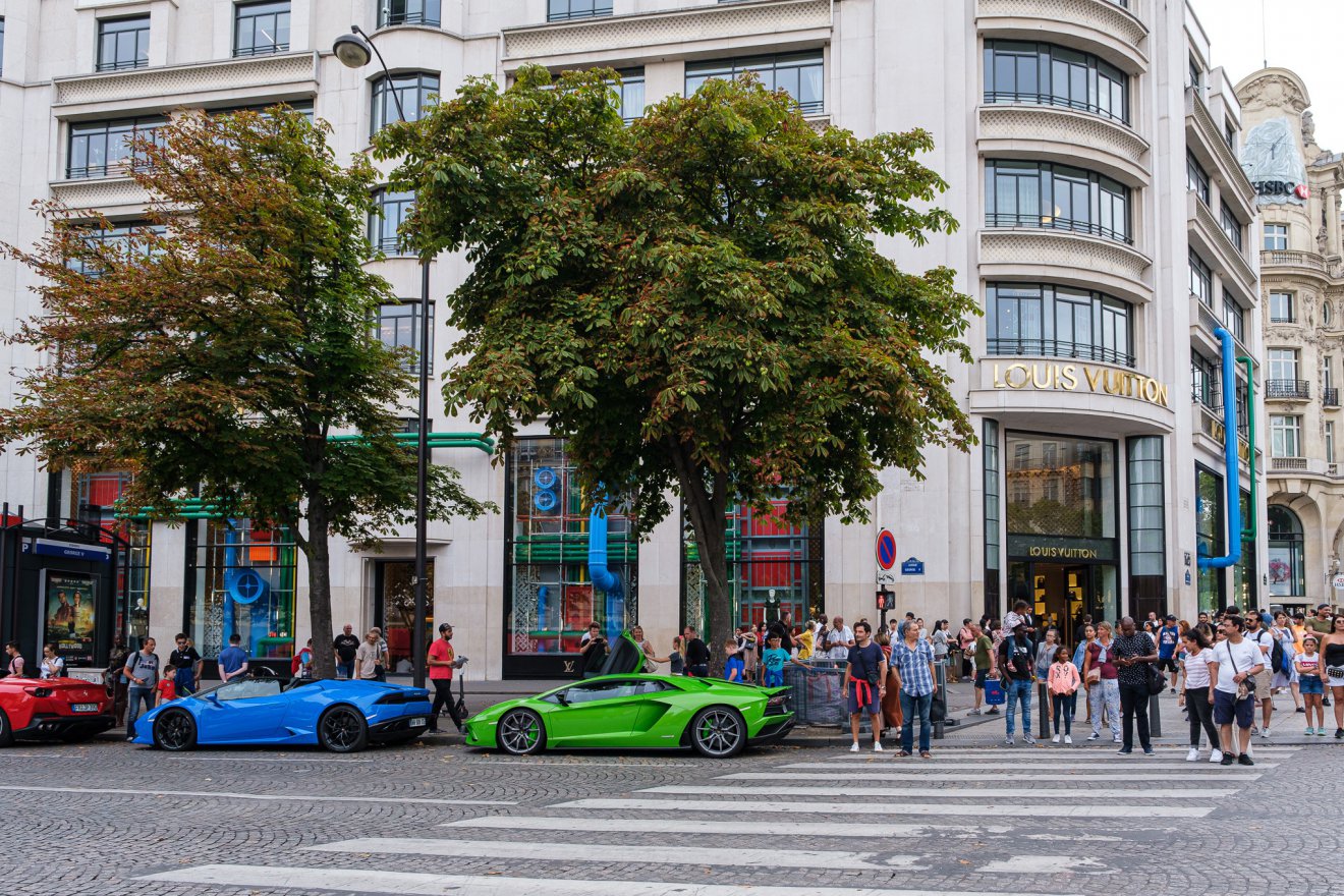 Supercars in front of the Louis Vuitton store